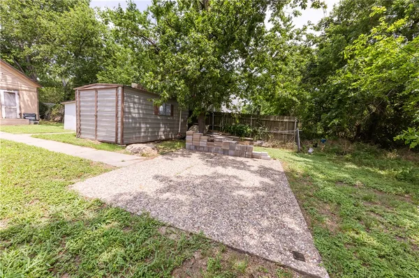 a backyard of a house with yard and tree