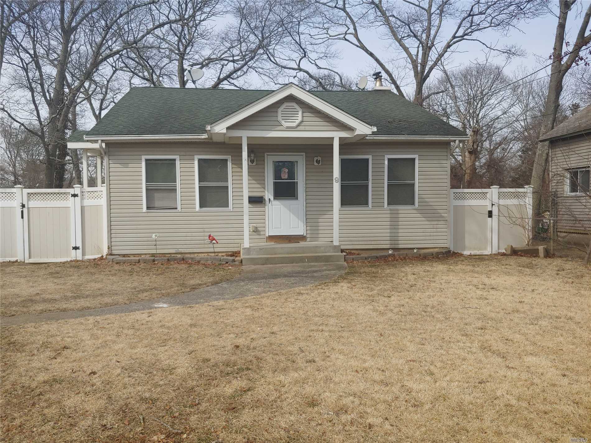 9 Seaford Road Mastic Beach, NY 11951 - Photo 1 of 1 a front view of a house with a yard and garage