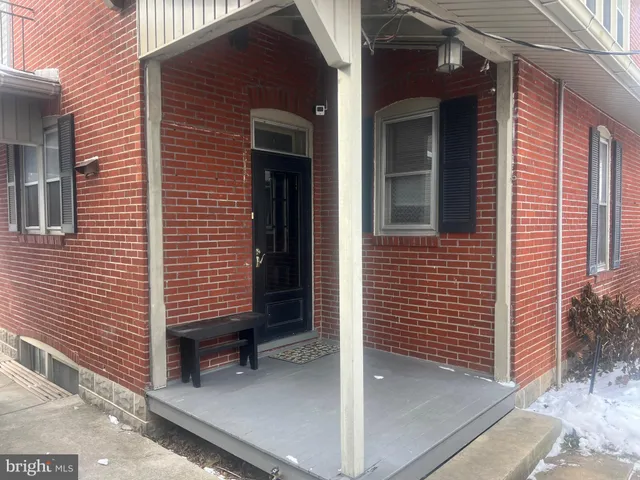 a view of a room with wooden floor and windows