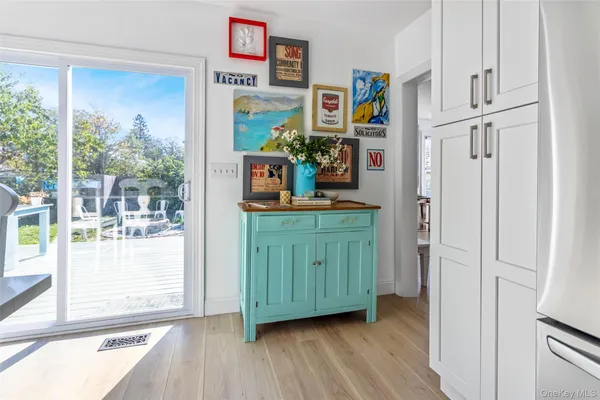 a kitchen with stainless steel appliances a stove a sink dishwasher and cabinets with wooden floor