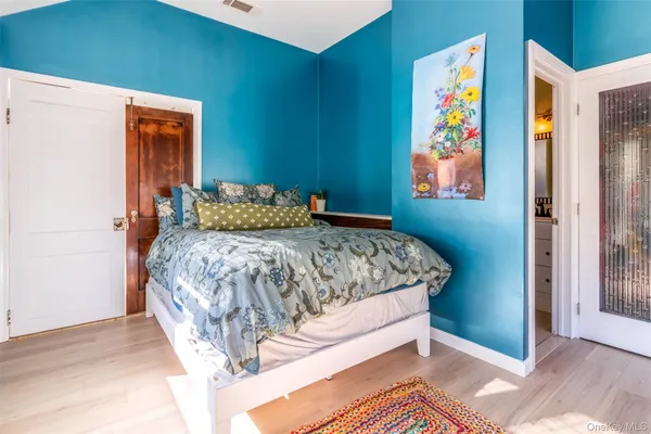 a view of a chair and table in backyard of the house