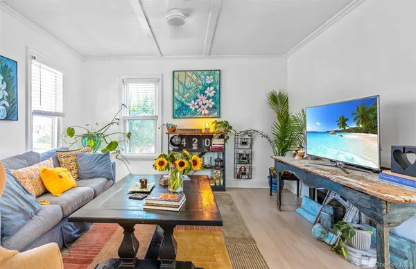 a living room with furniture a window and gym equipment