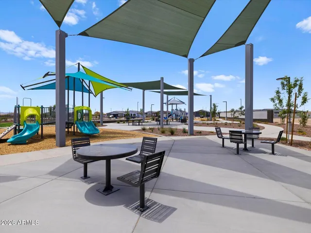 a sitting area with chairs and table in front of it