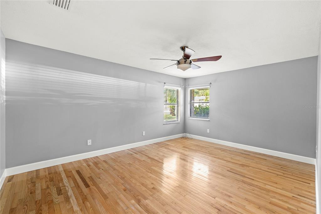 9508 Pine Terrace Court Windermere, FL 34786 - Photo 16 of 37 a view of empty room with wooden floor and fan