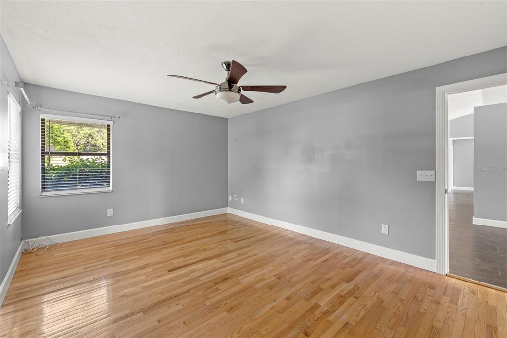 9508 Pine Terrace Court Windermere, FL 34786 - Photo 19 of 37 a view of empty room with wooden floor and fan