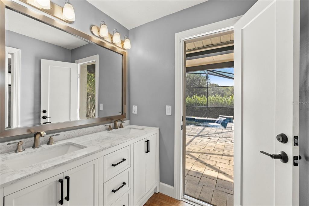 9508 Pine Terrace Court Windermere, FL 34786 - Photo 22 of 37 a bathroom with a granite countertop sink and a mirror