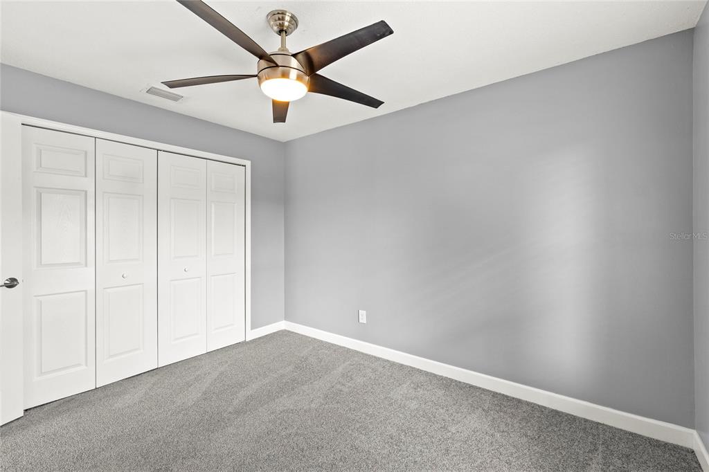 9508 Pine Terrace Court Windermere, FL 34786 - Photo 25 of 37 an empty room with a ceiling fan and a window