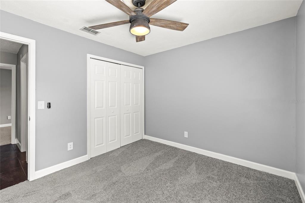 9508 Pine Terrace Court Windermere, FL 34786 - Photo 27 of 37 an empty room with a chandelier fan
