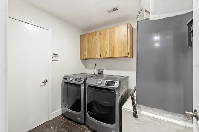 a utility room with a stove a washer and dryer