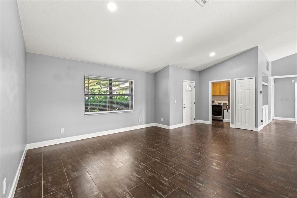 9508 Pine Terrace Court Windermere, FL 34786 - Photo 4 of 37 a view of an empty room with wooden floor and windows