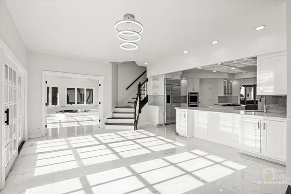 a kitchen with stainless steel appliances kitchen island granite countertop a sink and cabinets