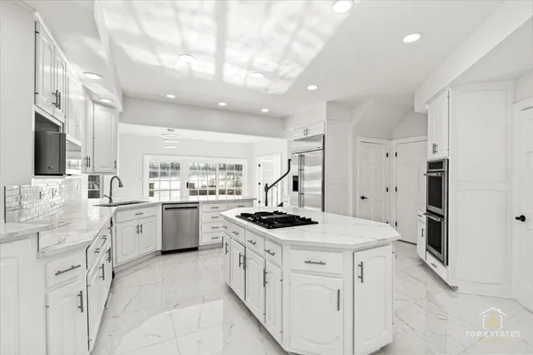 a kitchen with a sink stove and cabinets