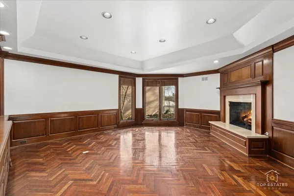 a view of an empty room with a fireplace and a window