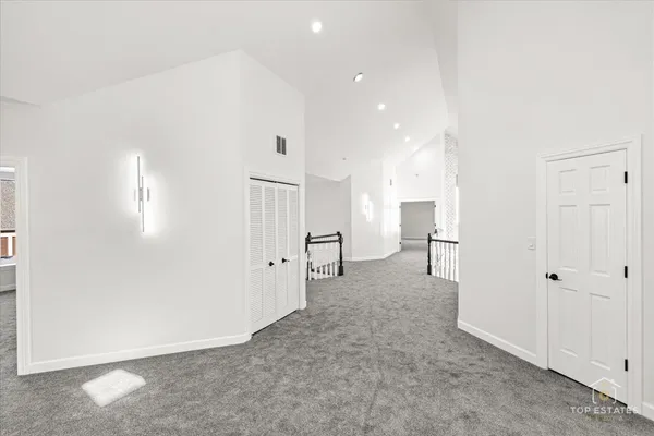 a view of a hallway with wooden shelves