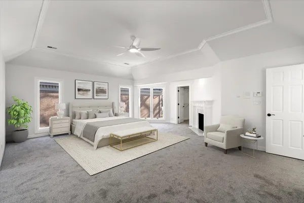 a spacious bedroom with a large bed and a chandelier