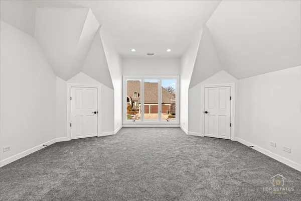 an empty room with cabinet and mirrors