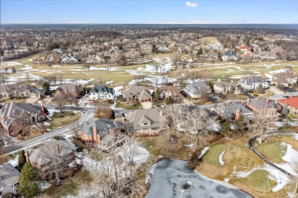 a view of a yard with snow on the road