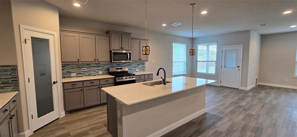 2432 O'Connor Rnch Drive Weatherford, TX 76087 - Photo 11 of 20 a kitchen with stainless steel appliances granite countertop a refrigerator a stove top oven a sink and dishwasher