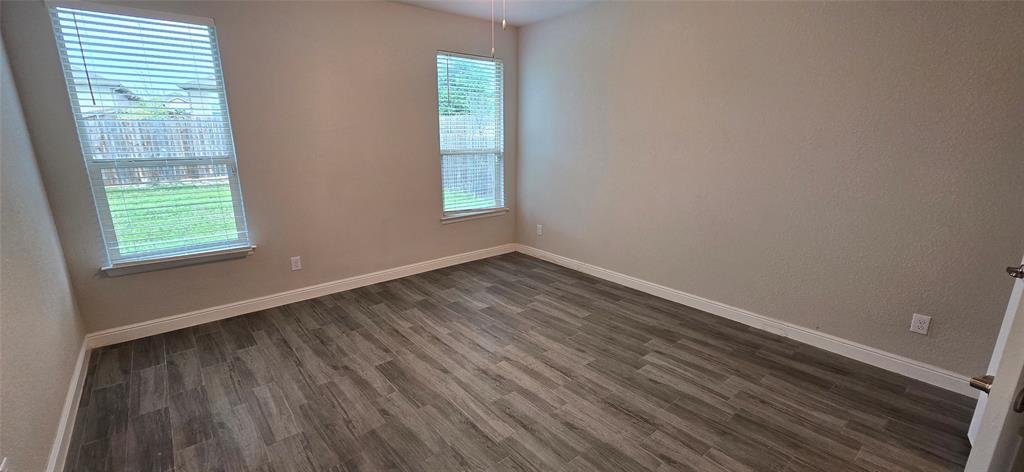 2432 O'Connor Rnch Drive Weatherford, TX 76087 - Photo 14 of 20 an empty room with wooden floor and windows
