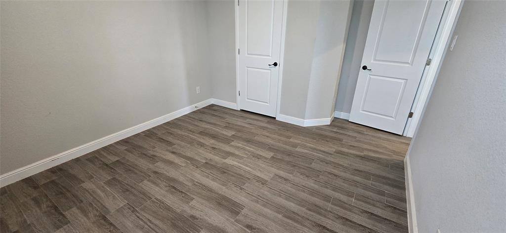 2432 O'Connor Rnch Drive Weatherford, TX 76087 - Photo 5 of 20 a view of an empty room with wooden floor
