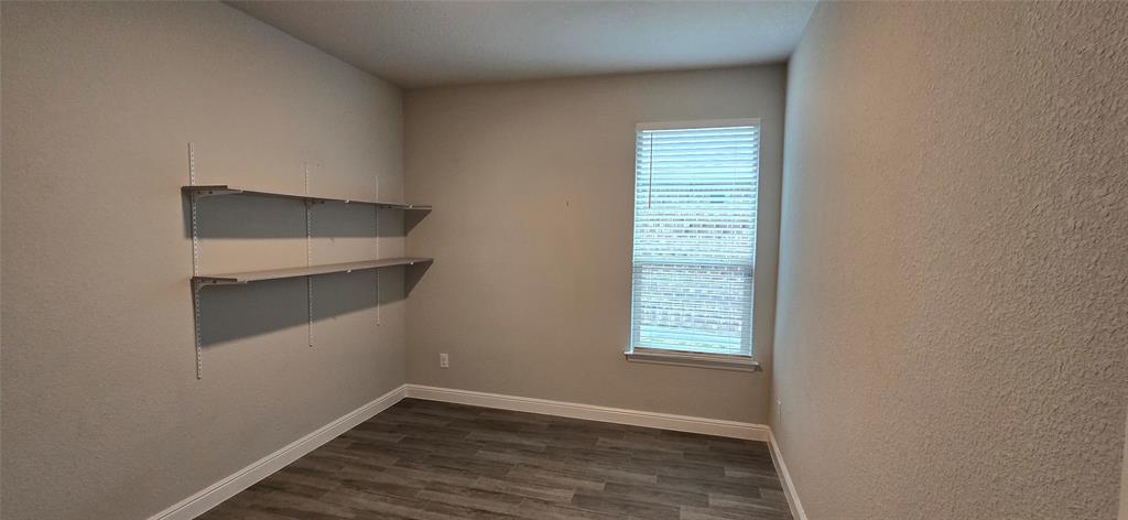 2432 O'Connor Rnch Drive Weatherford, TX 76087 - Photo 7 of 20 an empty room with wooden floor and windows