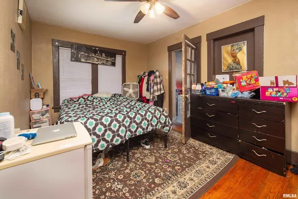 a bedroom with a bed and a dresser