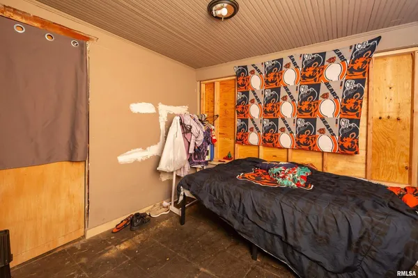 a bedroom with a bed and a table