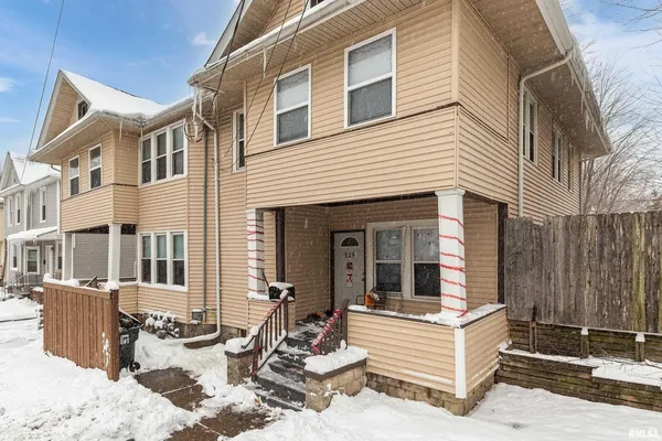 a view of a house with a yard and seating space