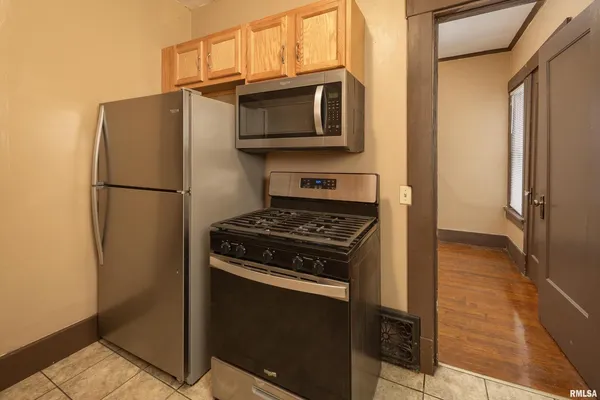 a kitchen with a refrigerator stove and microwave