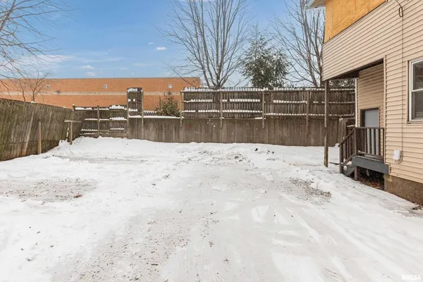 a view of roof covered with snow in front of house