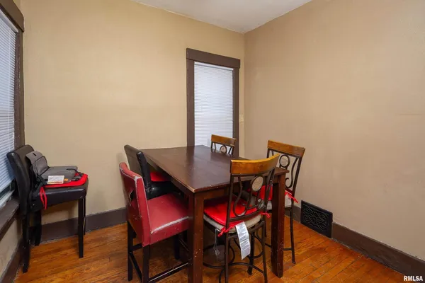 a view of a dining room with furniture and wooden floor