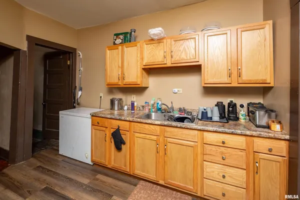 a kitchen with granite countertop white cabinets and stainless steel appliances