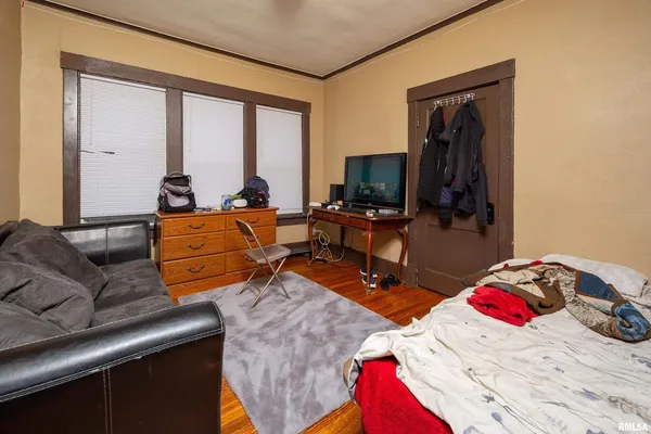 a living room with furniture a flat screen tv and a window