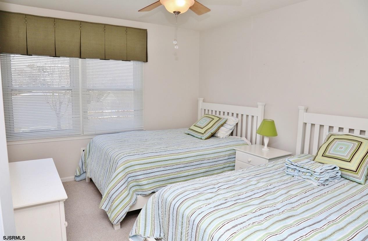 215 27th Street South Brigantine, NJ 08203 - Photo 19 of 23 a bedroom with a bed and a chandelier