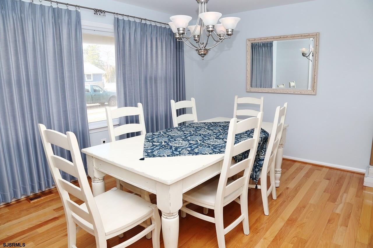215 27th Street South Brigantine, NJ 08203 - Photo 5 of 23 a view of a dining room with furniture and wooden floor