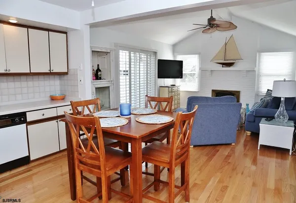 a view of a dining room with furniture wooden floor and chandelier