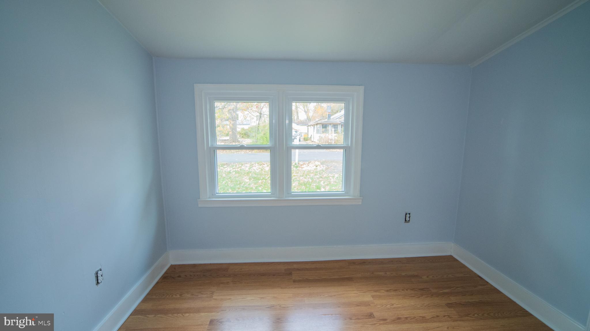 4955 Chestnut Street Shady Side, MD 20764 - Photo 11 of 22 an empty room with wooden floor and windows