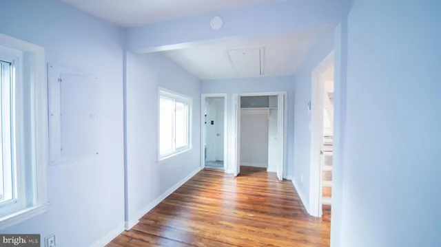 a view of a hallway with wooden floor