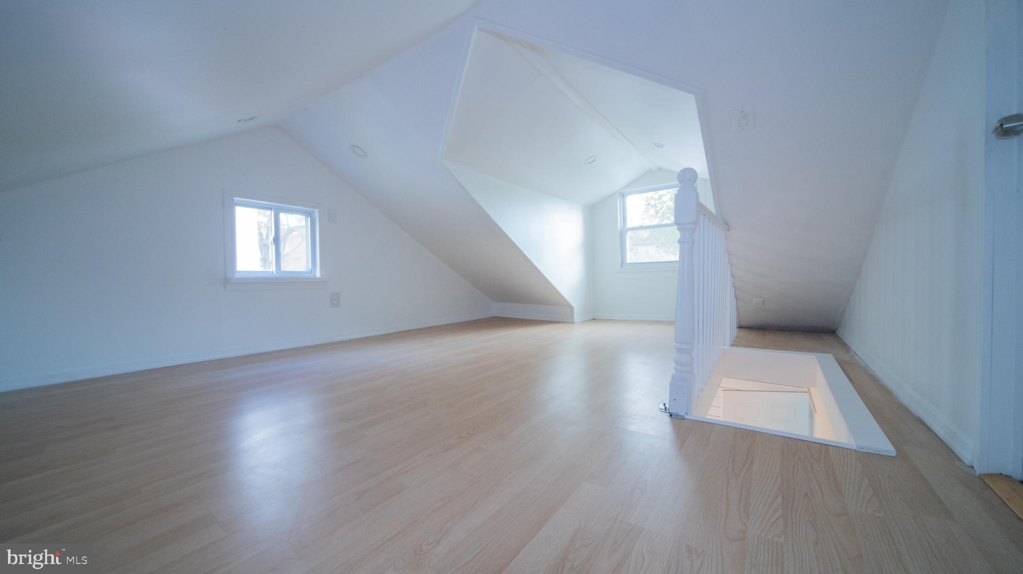 4955 Chestnut Street Shady Side, MD 20764 - Photo 17 of 22 an empty room with wooden floor and windows