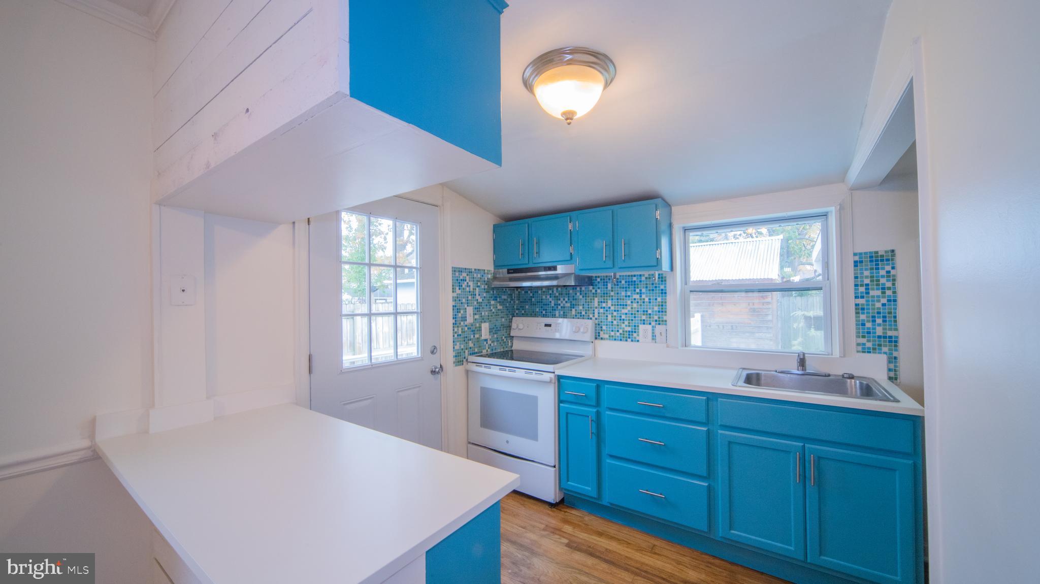 4955 Chestnut Street Shady Side, MD 20764 - Photo 6 of 22 a kitchen with a sink cabinets and window