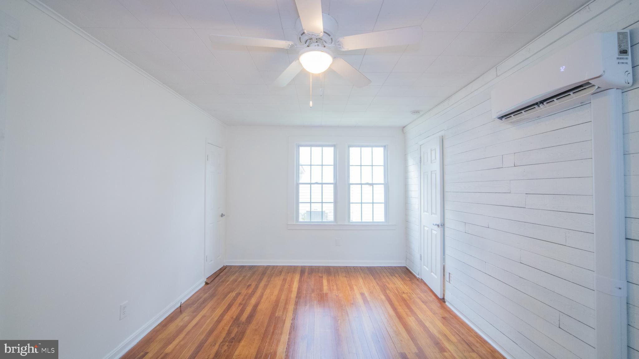 4955 Chestnut Street Shady Side, MD 20764 - Photo 10 of 22 wooden floor in an empty room with a window