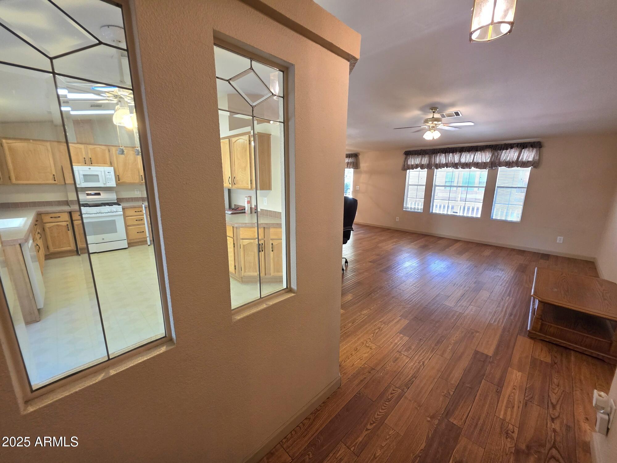835 West Overland Road Payson, AZ 85541 - Photo 19 of 31 a view of an empty room with wooden floor and a window