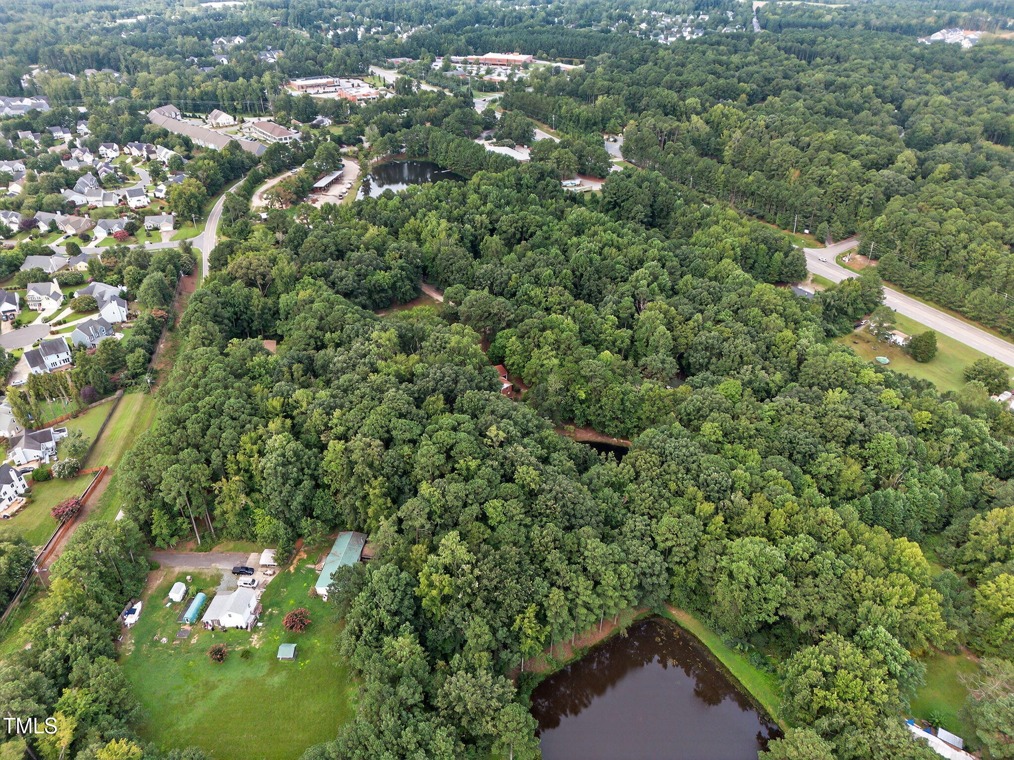 705 Oak Ridge Drive Cary, NC 27519 - Photo 13 of 31 an aerial view of a house with a yard and lake