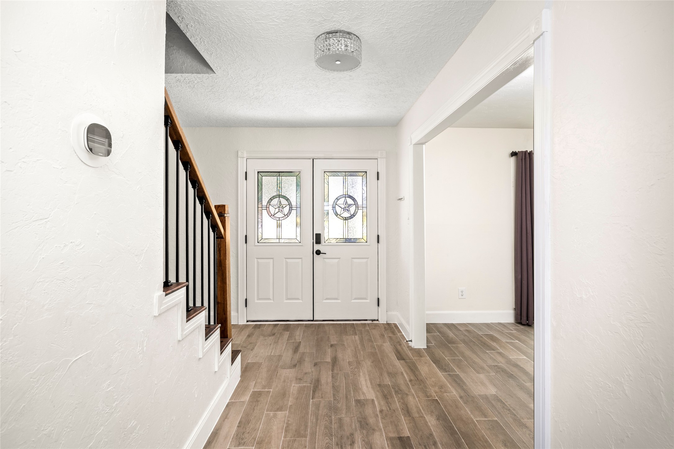 560 Landfall Lane Conroe, TX 77302 - Photo 10 of 41 An inviting foyer with double doors, with the formal living room and dining room on each side.