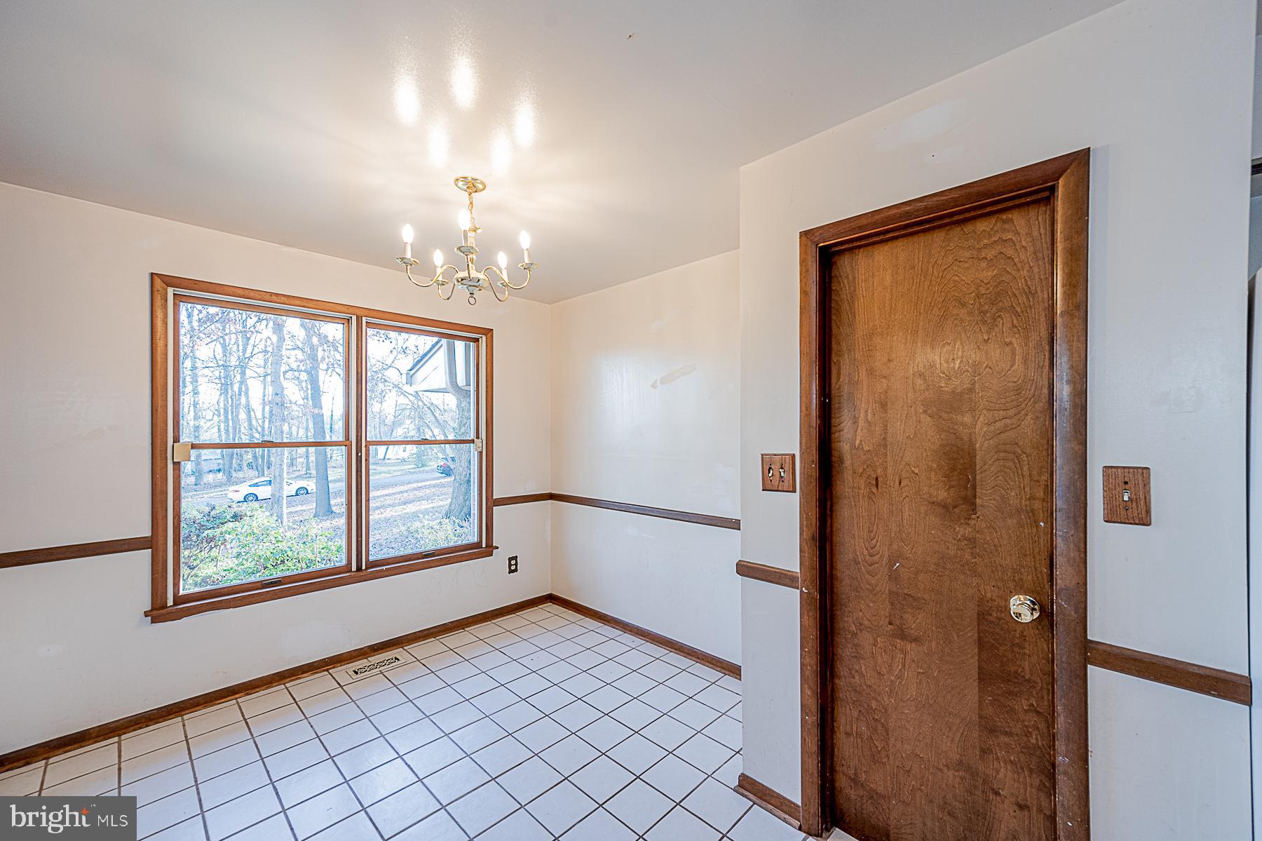 12008 Mettee Road Marriottsville, MD 21104 - Photo 13 of 36 a view of an empty room with window chandelier fan