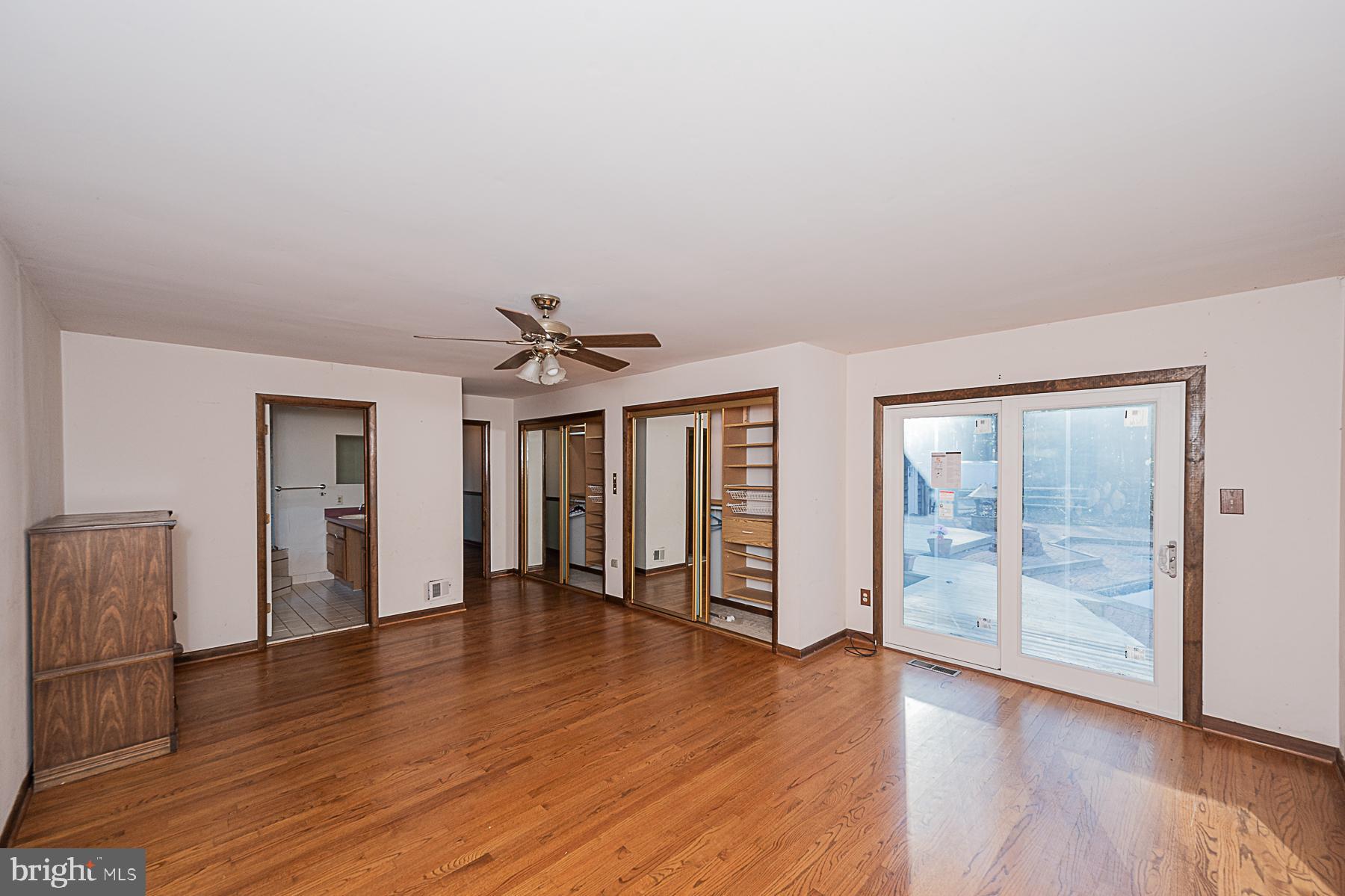 12008 Mettee Road Marriottsville, MD 21104 - Photo 17 of 36 an empty room with wooden floor and windows