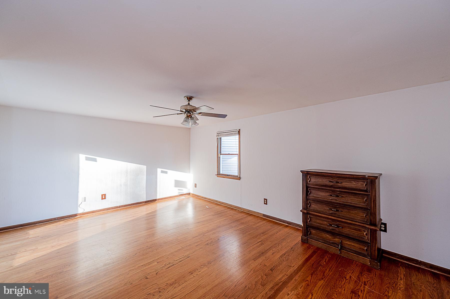 12008 Mettee Road Marriottsville, MD 21104 - Photo 18 of 36 wooden floor in an empty room with a window