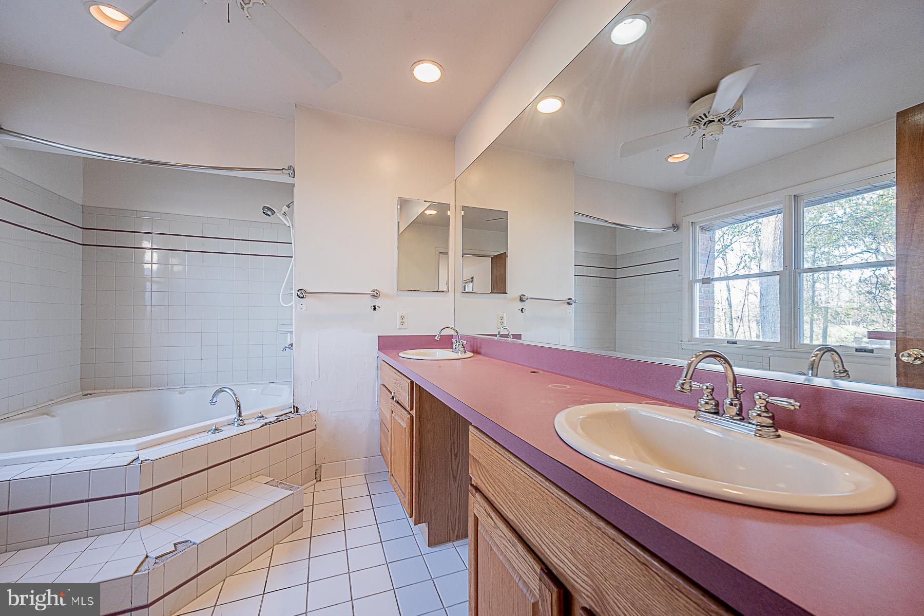 12008 Mettee Road Marriottsville, MD 21104 - Photo 19 of 36 a bathroom with a sink double vanity and a tub