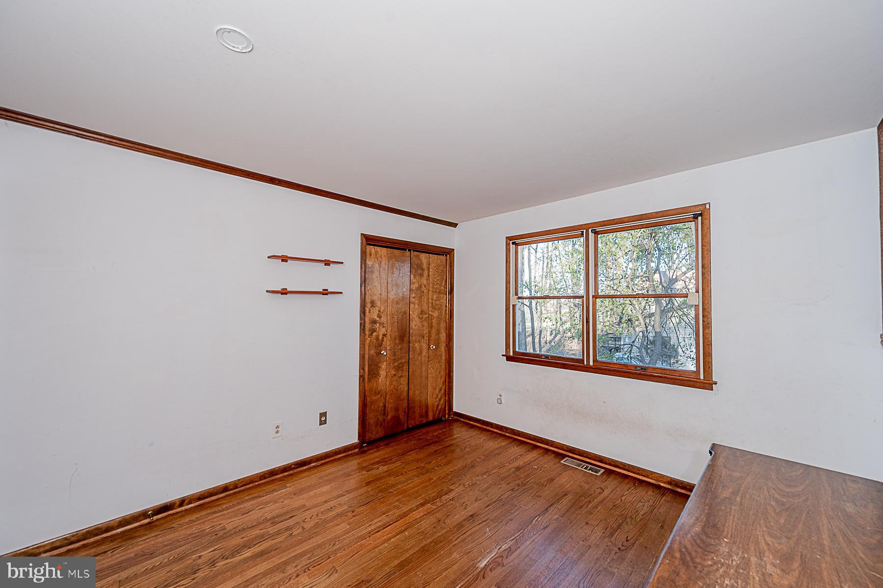 12008 Mettee Road Marriottsville, MD 21104 - Photo 20 of 36 an empty room with wooden floor and windows