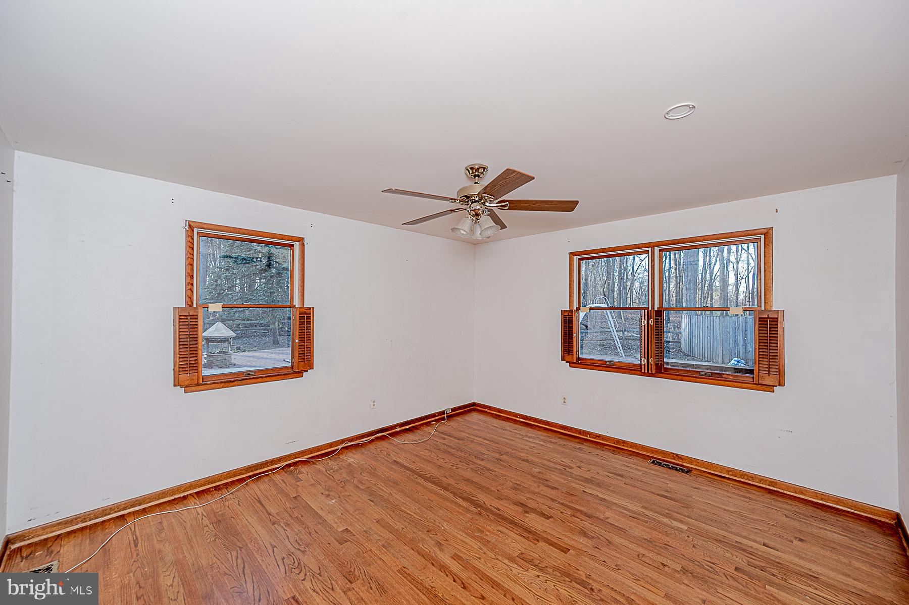 12008 Mettee Road Marriottsville, MD 21104 - Photo 21 of 36 a view of an empty room with wooden floor and a window